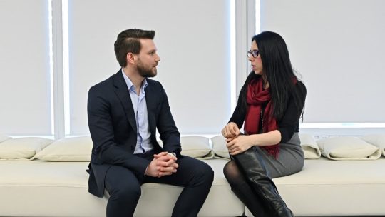 Image of two people talking.